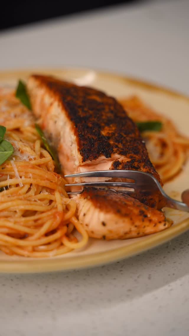 Salmon Tomato Spaghettini

You: Salmon tonight?
Me: Say less 

Pan roasted Salmon, Cherry tomato sauce, Spaghettini 

Ingredients:

* 3 salmon fillets
* Salt
* Black pepper
* Cajun seasoning
* 2 pints cherry tomatoes
* 2 cloves garlic (crushed)
* 1 tsp chili flakes
* 1 tsp salt
* ½ pack spaghettini
* Basil
* Parmigiano-Reggiano
* Olive oil

Method:

1. Season salmon with salt, black pepper, and Cajun seasoning. Heat oil in a pan over medium-high heat. Sear on both sides until deeply golden and cooked to your liking. Remove from the pan and let rest.
2. In the same pan, reduce heat to medium. Add cherry tomatoes and sauté until blistered. Add garlic and chili flakes. Use a masher or a fork to lightly crush the tomatoes into a sauce.
3. Add 1 tsp salt and black pepper. Let simmer until slightly thickened.
4. Cook spaghettini until al dente. Add directly into the sauce and toss.
5. Add basil and Parmigiano-Reggiano. Toss until glossy and emulsified. Taste and adjust seasoning.
6. Plate the spaghettini. Top with salmon. Finish with basil and Parmigiano-Reggiano.

#easyrecipes #salmonpasta #spaghetti