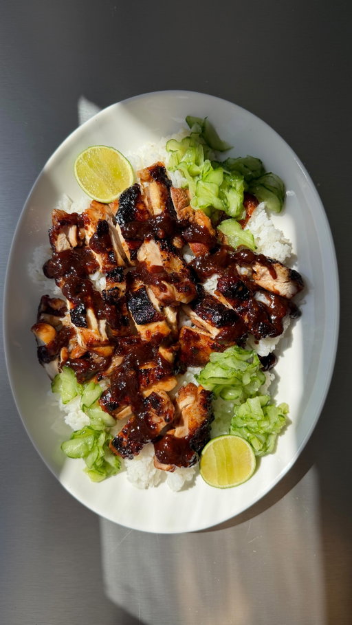 Sticky hoisin chicken thighs over fluffy rice with quick pickled cucumbers. Sweet, salty, sticky chicken, sharp crunchy cucumbers, kinda feels suspiciously like a fakeaway but with far less effort (and significantly better leftovers). She’s easy, she’s reliable, she’s delicious, we love her.🥒

For 4
4 large chicken thighs (or 8 smol ones)
4 tbsp hoisin sauce
2 tbsp soy sauce
1 tbsp rice vinegar
2 garlic cloves, grated
1 tbsp fresh ginger, grated
1 tsp sesame oil
1 large cucumber, roughly peeled & thinly sliced
1 tbsp salt
2 tbsp rice vinegar
1 tbsp sugar
Rice to serve 

Mix together the hoisin, soy, honey, rice vinegar, garlic, ginger and sesame oil. Coat the chicken thighs well and leave to marinate for at least 30 minutes (or overnight if you have time).
Thinly slice the cucumber and toss with salt, let sit for 5 mins then squeeze out the liquid and mix with the rice vinegar & sugar. Leave to pickle while everything else cooks.
Cook the chicken thighs in a hot frying pan for 7-10 mins on each side (depending on how big), basting with any leftover marinade until sticky, caramelised and cooked through.
Slice the chicken and serve over fluffy rice with the pickled cucumbers on the side and more of the cooked marinaded spooned over the top
