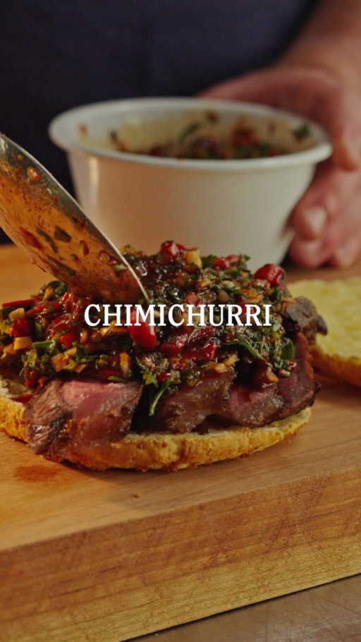 Vibrant and piquant, chimichurri is one of those condiments that instantly transforms a dish. Here Troy makes a flavour packed steak sandwich using our chimichurri. 
And, here is our recipe for Chipa, the South American cheese bread he’s made it with: 

Ingredients
220g tapioca flour
300g sharp cheddar, shredded
30g parmesan, finely grated
84g butter, melted and cooled
2 eggs (approximately 110g)
30ml whole milk
½ tsp salt
1 tsp baking powder

Method
Preheat the oven to 190°C and line a baking tray with baking paper.

In a large bowl, combine the tapioca flour, salt and baking powder. Add the cheddar and parmesan, mixing well with your hands. In a separate bowl, whisk together the melted butter, eggs and milk.

Pour the wet ingredients into the dry ingredients and mix until a dough forms. The dough should be soft but firm enough to roll into balls. If it feels too sticky, add a little extra tapioca flour, one spoonful at a time.

With damp hands, roll the dough into 8 balls and place them evenly spaced on the tray. Bake for 20–25 minutes, or until golden and puffed, then serve warm with grilled porterhouse steak and our housemade chimichurri.
⁠