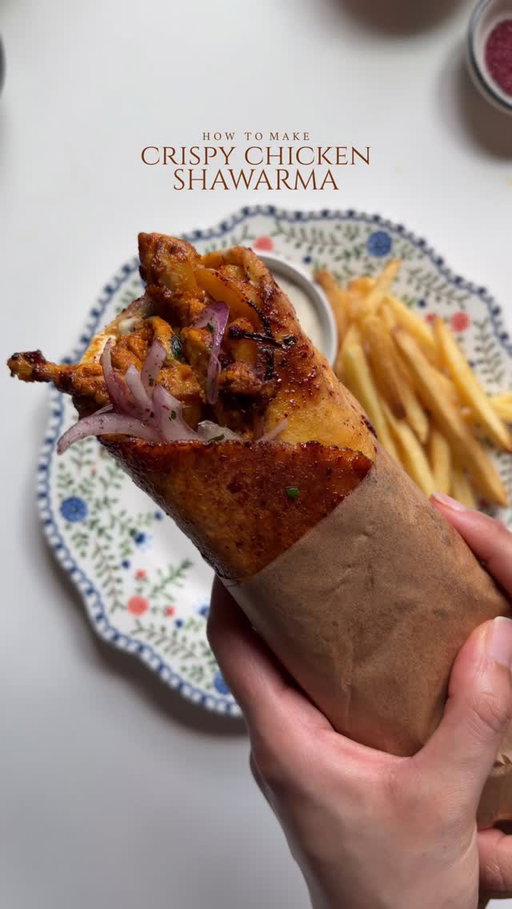 Crispy chicken shawarma 🌯 

Ingredients 

For the chicken:

2 lb boneless chicken thighs, cut into pieces 
Salt to taste 
1 tsp black pepper 
1/2 tsp red chili powder 
1 tbsp smoked paprika powder 
1 tbsp garlic powder 
1 tsp cumin powder 
1/2 tsp coriander powder 
1/2 tsp turmeric powder 
1 tsp onion powder 
1 tablespoon lemon juice 
2 tbsp toom garlic dip 
1 tsp red pepper paste
1 tbsp tomato paste 
2 tbsp oil ( for marinating ) + more for cooking the chicken 

For the shawarma glaze:

1/2 cup oil 
1 tbsp red pepper paste or tomato paste 
1 tbsp sumac 
Pinch of salt
2 tbsp pomegranate molasses 

For the sumac onion:

1 red onion, thinly sliced
Squeeze of lemon juice 
1 tsp sumac
1 tbsp parsley, freshly chopped 
Salt to taste 
1 tbsp oil

To assemble 

6 thin pita bread 
1 cup tomato, seeded and diced
French fries
8oz Toom garlic dip

Method:

Marinade the chicken: In a bowl, combine chicken with salt, black pepper, red chili powder, smoked, paprika, garlic powder, cumin, coriander, turmeric, onion powder. Add lemon juice, toom garlic dip, red pepper paste, tomato paste, oil.  Mix well until the chicken is fully coated. Cover and marinate for at least 2 hours, or overnight.

For the glaze : Mix oil, red pepper paste, sumac, salt, and pomegranate molasses in a small bowl. Set aside.

For Sumac Onions: Combine sliced onion, lemon juice, sumac, parsley, salt, and oil. Toss well and set aside.

Heat oil In skillet over medium high heat. Add the marinated chicken and cook in batches for about 8–10 minutes until fully cooked and slightly charred.

Assemble the Shawarma: Take the pita wrap. Spread toom garlic sauce, add chicken, fries, sumac onions, fries and diced tomatoes. Roll the pita tightly into a wrap. Toast it in a skillet for 1–2 minutes on each side. Then, coat the wrap with shawarma glaze and cook until it’s golden and crispy.

Serve warm with more toom garlic sauce and fries.

#recipe #shawarma #chickenshawama