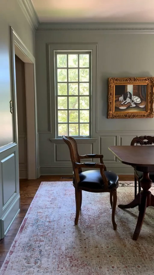I wanted the dining room to feel layered, historic, cozy, and collected.. like it had always belonged here.

After months of living with the space, I finally landed on Carolina Gull, and the second it went on the walls, everything changed. The color shifts throughout the day depending on the light. Sometimes it leans soft green, sometimes muted gray, and by evening it almost takes on that moody old-world feel I love so much. It somehow made the molding, brass chandelier, wood tones, and antique pieces all stand out more instead of competing with each other.

We used eggshell on walls and satin on all the trim 

The wild part is the room doesn’t actually feel darker to me now… just warmer and more intentional.

It finally feels like the kind of Colonial dining room I pictured when we moved in. I may add wallpaper down the road, but for now it’s perfect.

I went against the majority vote of moody blue. Were you team moody blue or the green I chose?