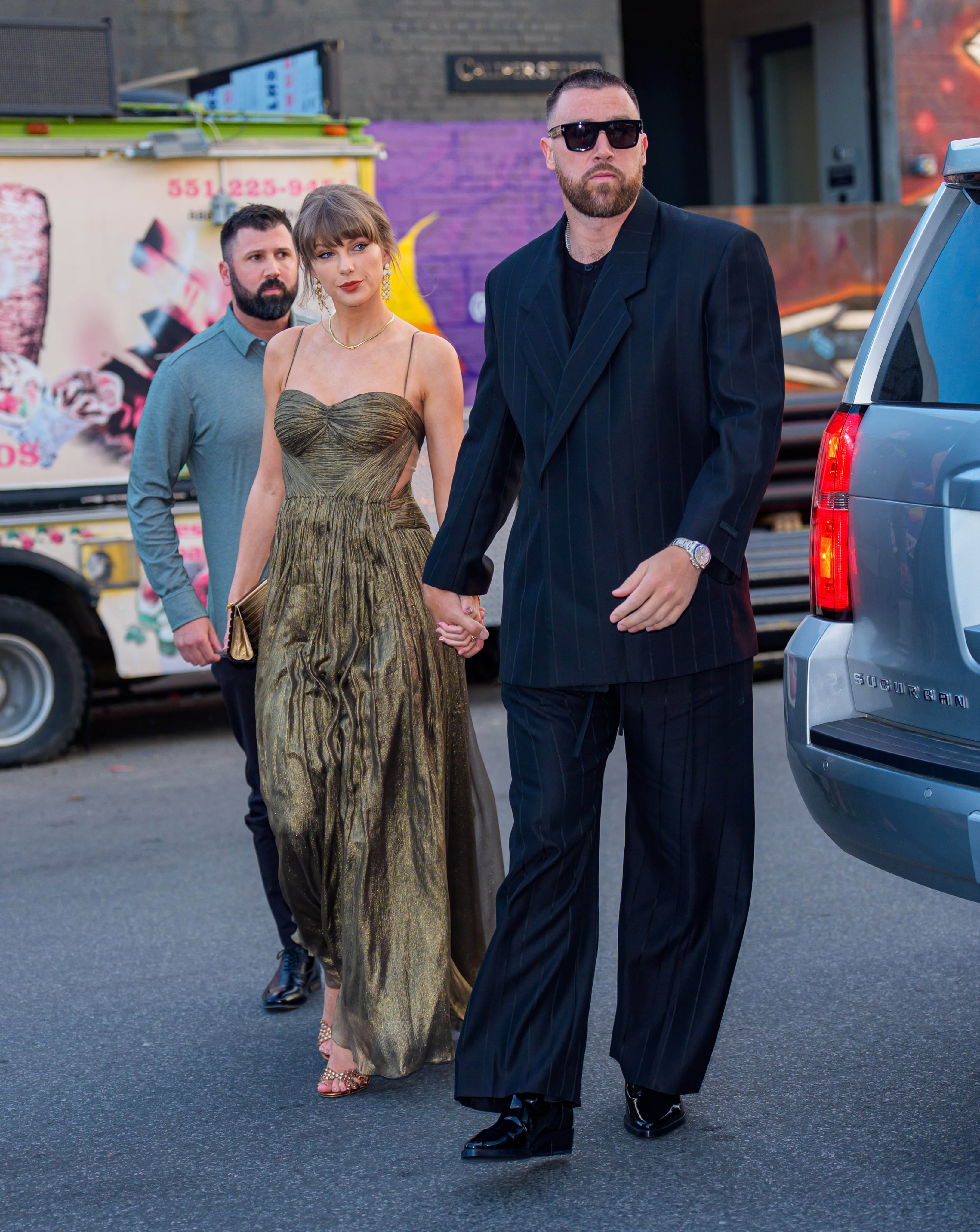 @taylorswift and Travis Kelce (@killatrav) are making New York City their runway this week. The couple kept their fashion metallic and tailored, respectively, as they stepped out in Brooklyn last night—a change from their usual Manhattan haunts.