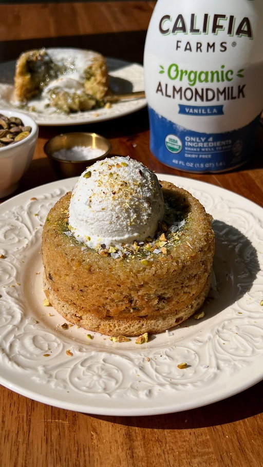 warm, gooey pistachio cream flowing out of a soft, tender pistachio cake — does it get better than that? i think not 😌 recipe below OR comment ‘RECIPE’ to get the link sent to you 🤎

Pistachio Cake:
- 2 cups (240g) all-purpose flour
- 2 1/4 tsp (9g) baking powder
- 1/2 tsp (2g) baking soda
- 1/4 tsp (2g) salt
- 2/3 cup (160ml) @califiafarms Organic Vanilla Almondmilk, room temp
- 2 tsp (10ml) apple cider vinegar or lemon juice
- 2/3 cup (100g) shelled unsalted pistachios
- 1 cup (200g) granulated sugar
- 6 tbsp (90g) salted vegan butter, room temp
- 3/4 cup (180g) Greek-style dairy free yogurt, room temp
- 2 tsp (8g) vanilla extract
- Optional: 1/2 tsp (2g) almond extract
Pistachio Cream Center:
- 1/2 cup (120g) pistachio cream 

Instructions:
Line a small baking sheet or plate w/ parchment paper. Scoop out full tbsp (or 2 tbsp) of the pistachio cream & place them onto the parchment paper. Do 4 if using 12oz ramekins, or 8 for 8oz ramekins. Place into the freezer for at least 30 mins, or until solid.
Preheat oven to 350F. Grease 4, 12oz ramekins OR 8, 8oz ramekins w/ vegan butter. Place onto a baking sheet.
In a small bowl, whisk together the almondmilk & vinegar.
In a medium bowl, whisk together the flour, baking powder, baking soda & salt. 
Add the pistachios & sugar to a food processor or blender; blend until finely ground. This is your pistachio sugar!
In a separate large bowl, combine the pistachio sugar & butter. Beat until creamy, about 2 mins.
Then whisk in the yogurt, vanilla & almond extract until fully incorporated.
Alternate between adding the dairy free ‘buttermilk’ & dry ingredients in 2 portions, mixing between each, until just combined.
Divide ~1/2 of the pistachio batter evenly among the ramekins & spread into an even layer.
Place a frozen pistachio disc in the center of each ramekin; gently press down. Divide remaining batter evenly among the ramekins & spread into an even layer.
For 12oz ramekins, bake at 350F for 30-33 mins. For 8oz ramekins, bake at 350F for 25-28 mins, or until the tops are lightly golden. 
Remove from oven & let sit for 1-2 mins. Then run a knife along the edges & invert. 
Serve & enjoy!

#califiapartner
