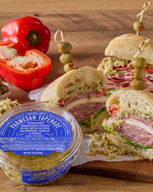 📸: “The Italian Deli Meat Sandwich with Parmesan Tapenade” featuring #TraderJoes Parmesan Tapenade • Tap the link in our bio to get the #TJsRecipe
•
On a purely technical level, Trader Joe’s Parmesan Tapenade is made from thick shreds of umami-rich Parmesan cheese, which have been combined with a medley of diced garlic, jalapeños, and Manzanilla olives, then seasoned with herbs and marinated in a blend of oil and red wine vinegar.
•
On a practical level, it’s a catch-all condiment, dip, and spread that adds briny, spicy, savory zing to all sorts of dishes—think crusty bread, roasted potatoes, sandwiches, pastas, steaks...
•
And on a more conceptual level, it’s precisely the kind of irresistibly unique, everyday treasure that you can only discover at your neighborhood Trader Joe’s!
—
• In Our Refrigerators •
