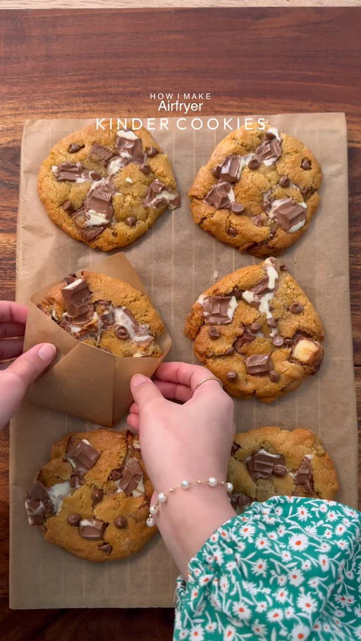 Crispy edges, soft and gooey center Airfryer kinder cookies 

Yields: 8-9Cookies
INGREDIENTS:
•115g cold chopped unsalted butter
•80g caster sugar
•80g light brown sugar
•150g Kinder chocolate, chopped into chunks, plus an extra 50–60g for topping after baking.
•238g plain flour 
•½ tsp salt
•1½ tsp baking powder
•¼ tsp baking soda
•1 egg + egg yolk 
•½ tsp vanilla

INSTRUCTIONS:
•In a large mixing bowl, add the cubed butter and whisk until slightly creamy. Add the white sugar and light brown sugar, then whisk together until well combined and fluffy.
•Add the eggs, vanilla extract, and Whisk until fully incorporated.
•Add the flour, baking powder, baking soda, and salt. Also add kinder chunks and Gently mix until just combined, do not overmix. 
•Portion the dough into 90-95g balls.
•Place the cookie dough balls onto a tray and freeze for at least 30 minutes (or overnight for best results).
•Preheat airfryer to 175 (350°F). Bake for 10-12 minutes or until the tops are lightly golden while the centres remain soft.
•Remove from the airfryer and top it up with more kinder chunks and chocolate chips (option) and let it cool 
•Serve warm with ice cream.
NOTE: 
•Let the cookies set for at least 30 minutes. Open the air fryer and let them cool inside for 10 minutes before removing, then allow to set fully or they may break.
•FREEZING IS IMPORTANT.
•Store any extra dough balls in an airtight container or freezer bag and freeze for later. Whenever a cookie craving hits, bake straight from frozen🫶🏻

#cookies #kindercookies #fyp #explorepage #foodstagram