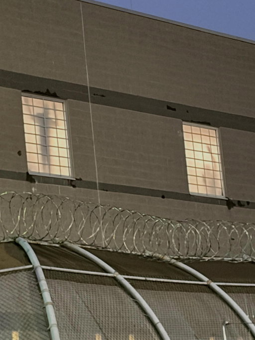 At Delaney Hall in Newark, NJ - beyond the barbed wire and concrete, ICE detainees on hunger strike stand in silhouette within windows they can't see out of, hoping people on the outside see them and remember they exist. #abolishice #delaneyhall