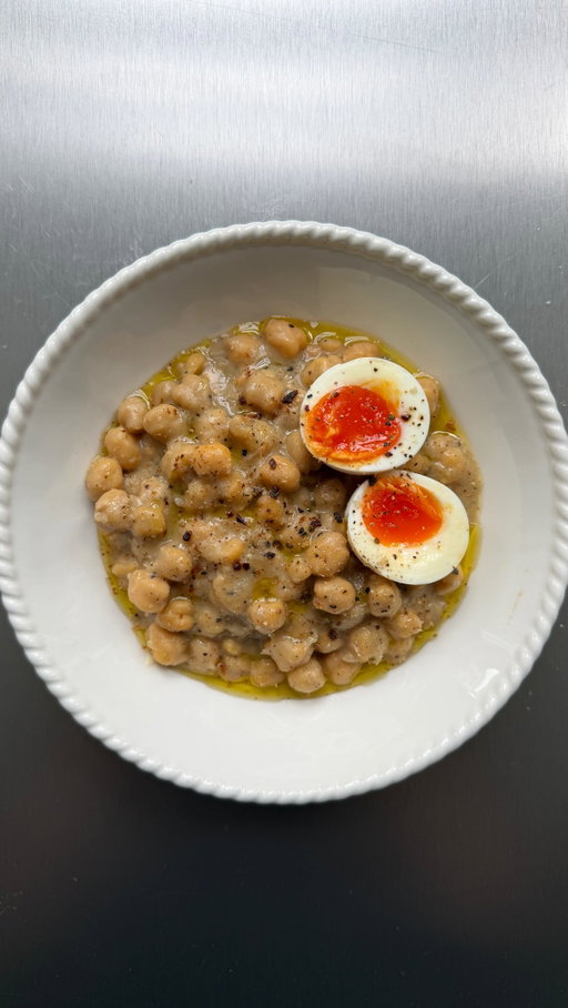 Round 3 of chickpea and egg toast smash, this time we have cacio e pepe chickpeas with jammy eggs on thick buttery toast and silky peppery chickpeas and heaps of parmesan melted through the broth. It just bloody works. 

For 2
1 jar chickpeas in broth, like @boldbeanco 
or 1 tin chickpeas, drained + 200ml stock/broth
2 eggs, always
1 tbsp whole black peppercorns, coarsely crushed
60g parmesan, finely grated
1 tbsp olive oil
2 slices good bread
Butter, for toast

1. Bring a saucepan of water to the boil and carefully lower in the eggs. Cook for 6½ minutes. Transfer the eggs straight into ice cold water and leave to cool slightly before peeling
2. Add the crushed peppercorns to a dry frying pan over medium heat and toast for 1 min until fragrant.
3. Pour in the chickpeas and all their broth, simmer for 3 mins then remove from the heat and stir through the parmesan, the broth should turn silky and emulsified. Season to taste
4. Plate with the eggs on top and smash on to your super buttery toast