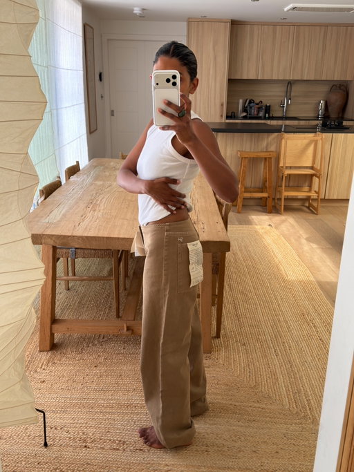 Finally got my hands on the @stillherenewyork Sport Jean in Pear - here are my notes 

• I’m probably a UK 6 at the moment. Usually a waist 23/24 in jeans. I wear a 23 in The Row Eglitta and all my Citizens of Humanity jeans
• Ordered both the 23 and 24 because I knew they’d sell out
• Girls online say to size down as they stretch - some kept their usual size and had them altered later
• Others said it depends on the look: TTS or one size up if you want them more relaxed with a little room
• Size down if you want them really fitted on the waist and bum
• Both sizes fit well, but the 23 felt a little tight around the crotch area - and I know I’d have to feel slightly uncomfortable for them to work, so I’m keeping the 24
• Love them when the elastic ankle tie is pulled tight. I’m 5’1 so the extra fabric feels a little heavy around the ankle
• Think I’m going to have them shortened slightly 📞 Diana @scobies_valetservice
• Will report back in a few weeks on stretch etc.

Hope that helps if you were debating sizing 🍐