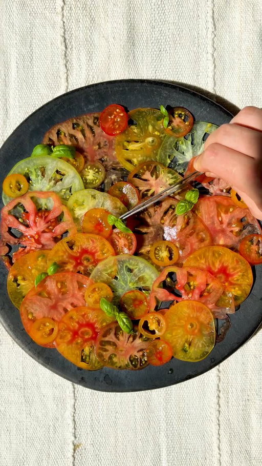 While in Oaxaca in April, I had an unforgettable salad made of thinly sliced heirloom tomatoes of all different colors laid out on a plate served simply. This morning I found these beautiful tomatoes at the Union Square Greenmarket and knew it was time. This is my Italian version served simply with extra-virgin olive oil, Traditional Balsamic of Modena, flakey sea salt, freshly cracked pepper, and basil leaves. Perfection.

#recipe #tomatoes #summertomatoes #salad