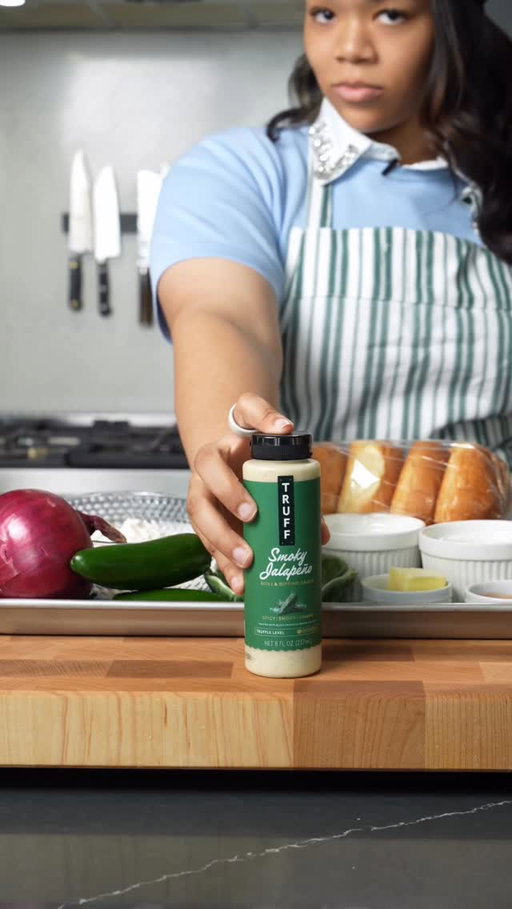 Crispy chicken sandwich with one special ingredient! 🎬 Watch to the end to find out which one got the callback 👀@sauce @wholefoods #Ad #TRUFFPartner #wholefoods #dinneridea
Ingredients
For the chicken:
	•	8 boneless skinless chicken thighs
	•	1 cup TRUFF Smoky Jalapeño Aioli (reserve 1/3 cup for the buns)
	•	1/2 cup buttermilk
For the dredge:
	•	1 1/2 cups all-purpose flour
	•	1/4 cup cornstarch
	•	1 tbsp paprika
	•	1 tsp garlic powder
	•	1 tsp onion powder
	•	1 tsp baking powder
	•	1 1/2 tsp kosher salt
	•	1 tsp black pepper
To fry and build:
	•	4 cups neutral oil
	•	4 brioche buns
	•	2 tbsp softened butter
	•	4 leaves green or butter lettuce
	•	1/2 cup dill pickle chips
	•	1/2 red onion, thinly sliced
Method
Marinate. Whisk together the aioli (remember, hold back that 1/3 cup) and buttermilk. Add the thighs, turn them so every piece is coated, cover, Mix the dredge. Whisk all the dry ingredients together in a wide shallow dish. 
Dredge. Pull each thigh straight out of the marinade and let only the excess drip off. Press it firmly into the flour. Let the dredged chicken sit while the oil comes up.
Heat the oil. Pour it into a heavy pot about 1 1/2 inches deep and bring it to 350°F. 
Fry. Work in batches and don’t crowd the pot. Six to seven minutes, flip halfway, pull it at 165°F internal. Drain on a wire rack, 
Toast the buns. Butter the cut sides and toast them in a dry skillet until golden, a minute or two.
Build it. Spread reserved aioli generously on both bun halves. Lettuce on the bottom, then the chicken, then pickles and red onion. Top bun on, press it gently, and eat it right away.