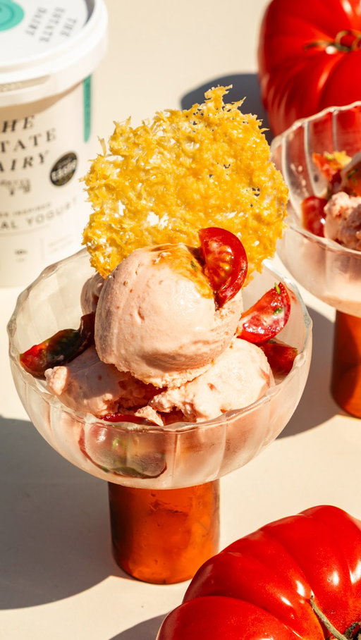 Tomato season is full of surprises, and this one could be our favourite yet! 🍅✨

Cold, creamy and showcasing the star of the season, Marmonde Beefsteak tomatoes, this tomato frozen yoghurt is the kind of scoop that gets everyone talking. Made using Greek Style Yoghurt from @theestatedairy , each serving is finished with parmesan crisps and fresh herbs. It’s sweet, savoury, completely unexpected and proof that tomatoes can do far more than salads. 💛

Here’s to trying something new this British Tomato Fortnight. 🇬🇧

#BritishTomatoFortnight

Prep Time: 20 minutes
Freeze Time: 6 hours or overnight
Total Time: 6 hours 20 minutes
Serves 4–6

Ingredients:

Frozen Yoghurt
300ml The Estate Dairy Yoghurt
500g Isle of Wight Beefsteak Tomatoes
200ml double cream
2 tbsp honey
Pinch of salt

Parmesan Crisps
Parmesan, grated

To Serve
Mixed Isle of Wight Cherry Tomatoes, chopped
Isle of Wight Olive Oil
Isle of Wight Balsamic Vinegar
Fresh basil
Fresh thyme
Flaky sea salt

Method
- Bring a pan of water to the boil. Score a small cross into the bottom of each Isle of Wight BeefsteakTomato, then carefully lower into the boiling water for 1 minute.
- Transfer immediately into iced water, then peel away the skins.
- Blend the peeled tomatoes until smooth.
- Stir the tomato purée into The Estate Dairy Yoghurt, double cream, honey and a pinch of salt until fully combined.
- Churn in an ice cream machine or transfer to a freezer-safe container and freeze for at least 6 hours or overnight.
- To make the parmesan crisps, spoon small piles of grated parmesan onto a lined baking tray. Bake at 180°C for 7–8 minutes until golden and crisp. Leave to cool completely.
- Toss the chopped Isle of Wight Cherry Tomatoes with olive oil, balsamic and thyme.
- Spoon the frozen yoghurt into bowls and top with the marinated tomatoes, parmesan crisps, basil, extra olive oil and a pinch of flaky sea salt.

- Serve immediately while the frozen yoghurt is still soft and creamy.