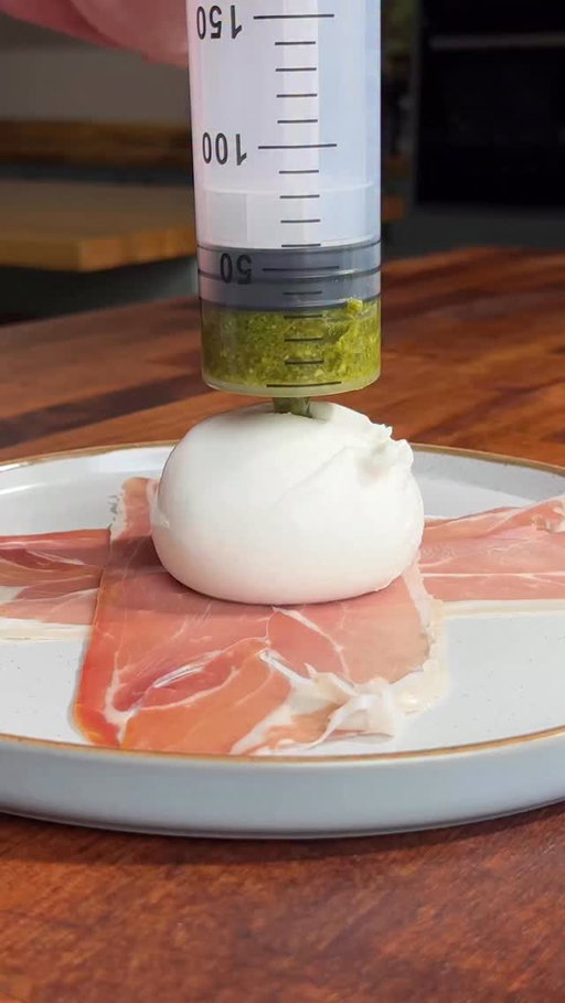 PESTO STUFFED BURRATA... this time even more unhinged

Creamy burrata injected with punchy pesto, wrapped in salty parma ham and air-fried until the outside is crispy and golden while the middle turns into a molten, cheesy dream. Crack one open and watch that pesto filled centre do its thing.

The most ridiculous way to eat burrata yet.

Recipe linked in our bio 💚 @hughwoodward