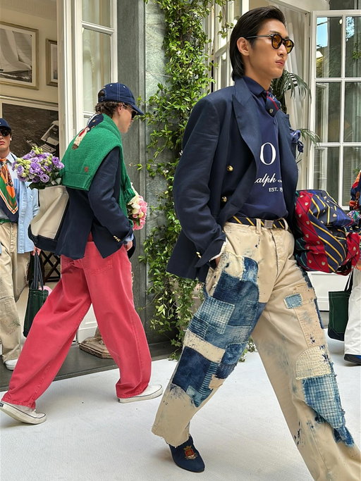 Ralph Lauren again proved he’s the greatest impresario of menswear, with a double header fashion show in Milan that was one for the books. The optimistic, collegiate spirit of the Polo collection and its boldly colorful, collaged, and artfully clashing American pennants, rugby stripes, colorful khakis mixed with Japanese indigo-dyed utility pants and lived-in denim, an Etonian bouquet-topped straw boater, and layered Madras plaids was masterful in its harmony. There simply isn’t styling like this anywhere else and it is jaw-dropping in its range and references. Purple Label’s refined elegance, in both highly contrasting and monochromatic looks in ivory and black, had an appealing ease and a maturity that was truly aspirational. I have never seen a more elegant short sleeved tee and pant combo in my days. We’re all taking notes. Bravo Mr. Lauren!