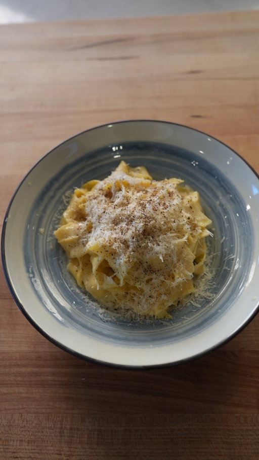 The best simple pasta! 

Recipe link in bio!

Serves 2

Ingredients 

Fresh pasta

220g high quality 00 flour
5 large egg yolks
1 large egg
½ tsp kosher salt
1 Tbsp olive oil

“Sauce”

6 Tbsp high quality fresh butter (ideally cultured), fully softened
2 cups Parmigiano Reggiano, finely grated
Black pepper for garnish

For the fresh pasta: pour the flour on a clean work surface and form a well in the flour. Add the eggs, egg yolks, salt and olive oil to the well and begin to mix with a fork. Once the eggs are homogenous begin to incorporate some of the flour a little at a time. Once the mix is thick enough that it wont run all over the place, switch to a bench scraper and scrape and fold together to form a rough dough. Use your hands and knead for 6-8 minutes until you have a smooth and strong dough. Wrap in plastic and rest for 20-30 minutes. 

Set a pot of water to boil. 

Flour a work surface and cut the dough in two. Flour the dough and roll out thin enough to fit in the pasta machine, or you can just fully roll the pasta out by hand. Run the pasta though the machine then the fettuccine attachment. Set the finished pasta aside. If making by hand, roll it out and cut using a knife. 

Generously salt the boiling water and cook your pasta for 2-3 minutes until al dente. Drain and reserve 1 ½ cups of pasta water.
 
To a medium pot, add the softened butter along with the pasta. Turn the heat to very low, add a splash of pasta water and mix vigorously until the pasta is coated with a light butter sauce. Add the grated cheese and vigorously mix again until the cheese is melted, using the pasta water to form a sauce. 

Twirl your pasta into bowls, top with additional grated Parmigiano Reggiano and fresh cracked black pepper. Enjoy!