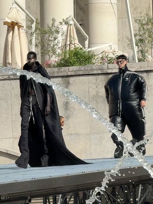 On a hot Paris morning @rickowensonline debuted a new collaboration with @adidas for SS27 which includes a technical running shoe, climacool technology, jogging suits, sharp-tailoring, latex capes and chaps. Swipe to see the collection.