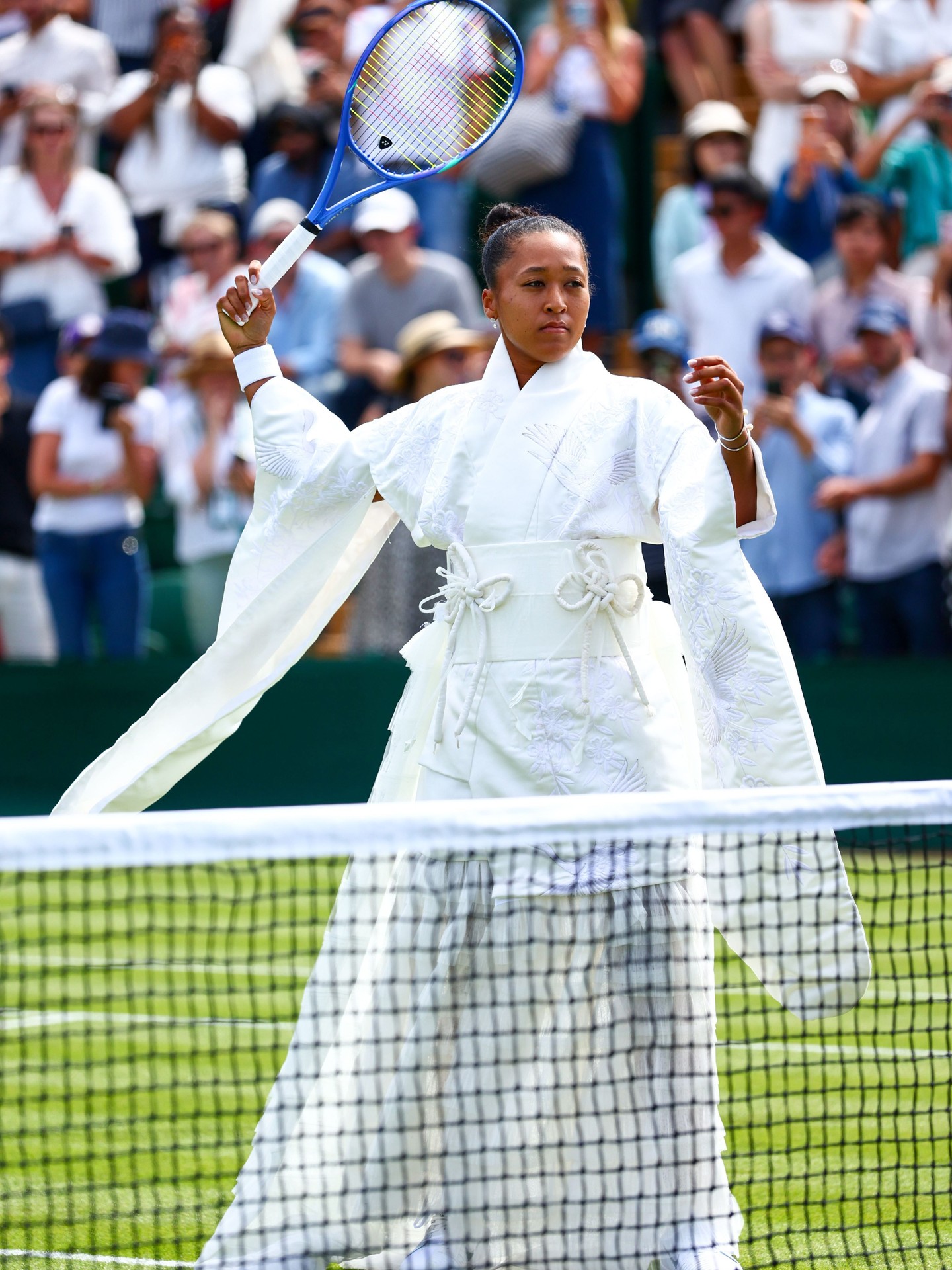 TALK ABOUT A GRAND SLAM 🎾

@NaomiOsaka just made her highly-anticipated #Wimbledon 2026 entrance in an all-white gown inspired by the traditional kimono. The look, entitled “Evolving Ceremony,” was created by Japanese designer @_hanayagi. It was made from materials upcycled from vintage kimonos, a traditional shiromuku wedding dress, plus a deconstructed wedding dress. A serve indeed!

Photos: Getty, James Marsh/Shutterstock