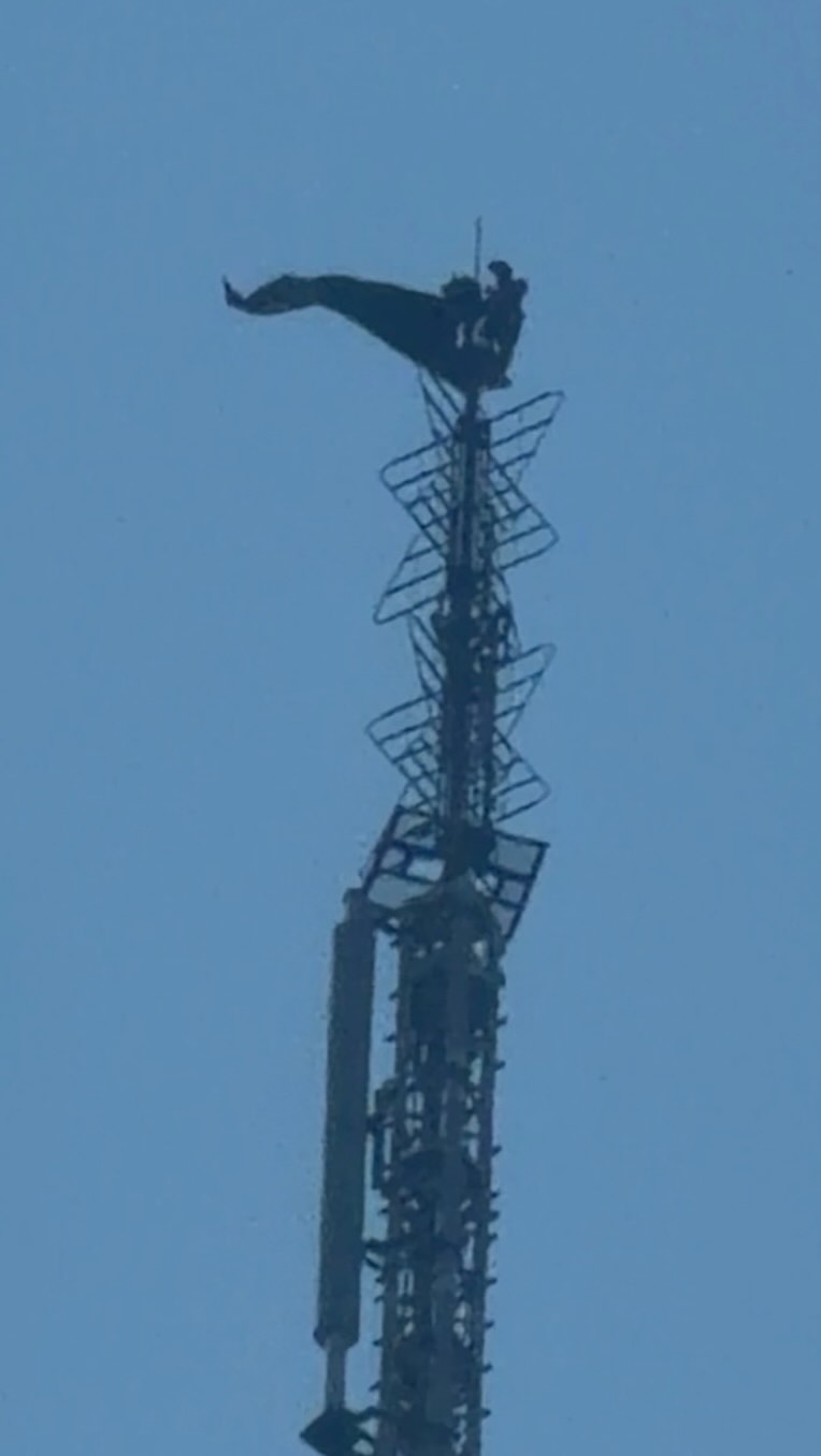 We can see the two people on top of the Empire State building from the office