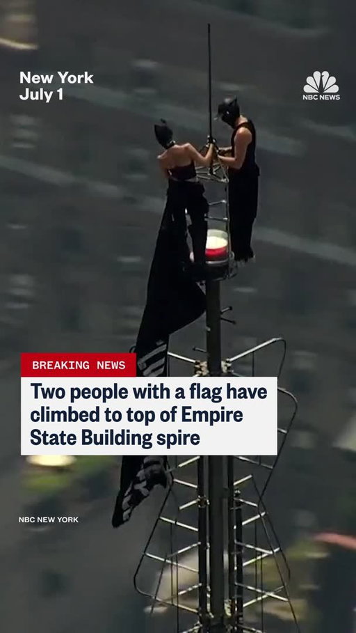 Two people climbed to the top of the Empire State Building, unfurled a pro-peace banner and appeared to start making out.

The pair, a man and a woman in dark outfits and masks, displayed a flag that read: “When the power of love beats the love of power, the world knows peace.”

In one especially surreal moment, the man got down on one knee and appeared to propose to the woman. The two embraced and kissed as NBC New York helicopters circled overhead.

The two eventually made their way down to street level, where they were taken into law enforcement custody, according to an official.