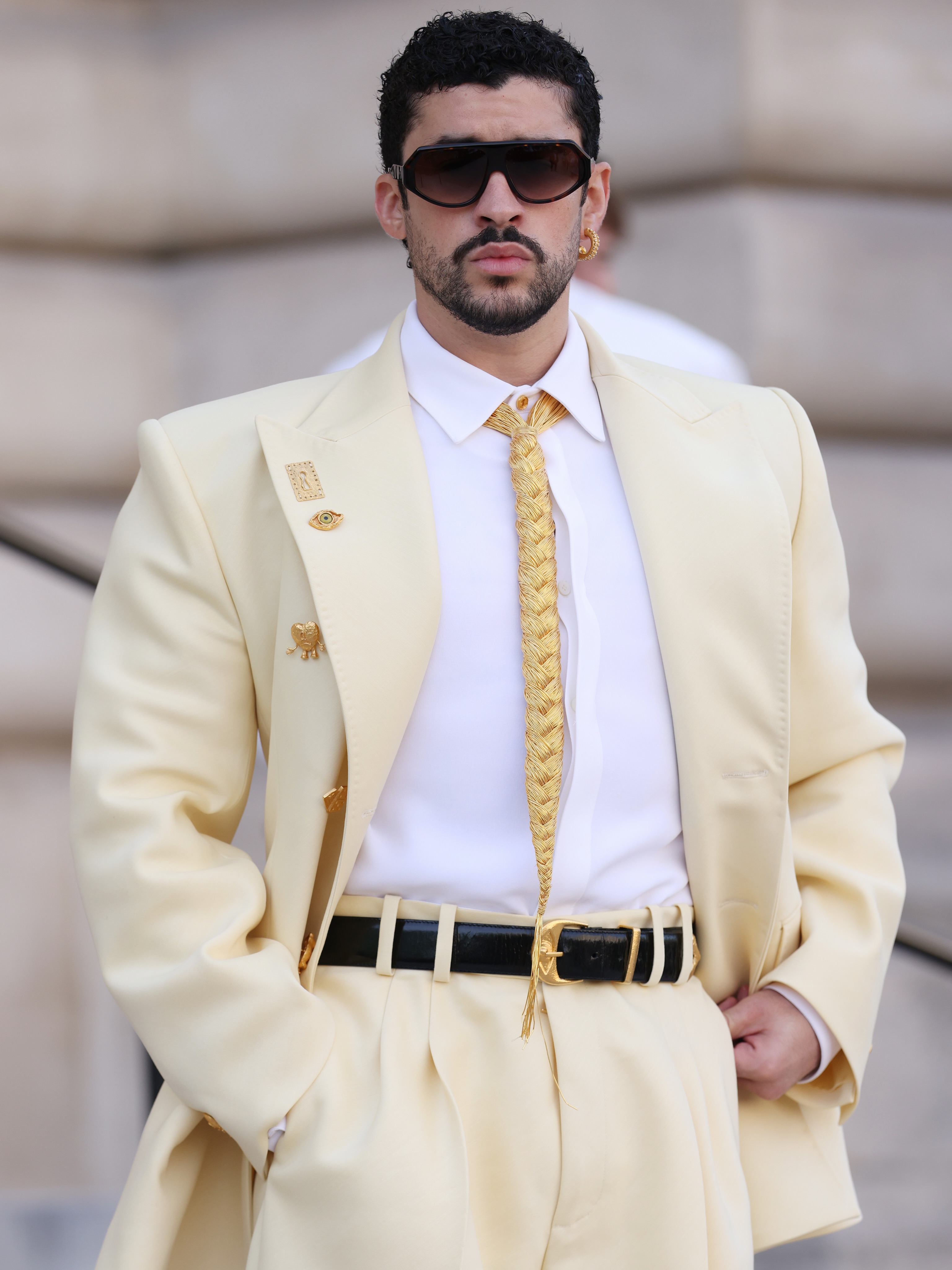 Good morning to all but ESPECIALLY to our fave #BadBunny, who showed up at today’s @Schiaparelli Haute Couture A/W ‘26 show in head-to-toe yellow looking every level of fab. (The braided tie! The buttons!) At the link in bio, read more about Benito's custom look, which features nods to a few of his most popular albums. 💛👑