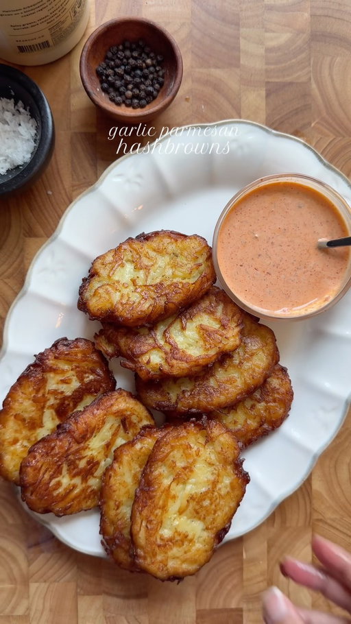 Garlic parmesan hashbrown 

Ingredients:

5 large russet potatoes
1 egg
2 tbsp cornstarch
Salt, to taste
1 tbsp garlic powder
1 tsp black pepper
1/2 cup freshly grated Parmesan cheese 
Oil, for frying

Method:

Peel and wash the potatoes, then partially boil them in salt water for 10 minutes.
Once cooled, finely grate the potatoes using a shredder.
In a bowl, combine the grated potatoes, egg, cornstarch, salt, pepper, garlic powder, and Parmesan cheese . Mix well.
Shape the mixture into oval-shaped hash browns.
Place the hash browns on a lined sheet and freeze for at least 1 hour. 
Heat oil in a pan over medium-high heat. Once hot, reduce the heat to medium-low.
Shallow-fry 3-4 hash browns at a time for 4 minutes on each side, until golden brown and crispy. Serve hot and enjoy!
#recipe #hashbrown