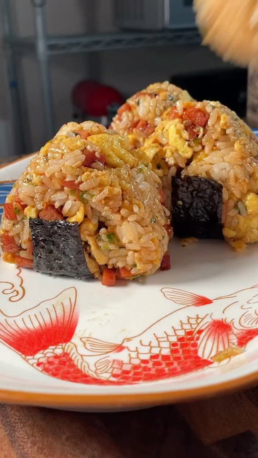 The perfect picnic food! 🍙 by @groovyfoodiess 

Ingredients:
-1 cup rice, cooked
-½ can Spam, cubed
-1 Tbsp soy sauce
-1 Tbsp sugar
-2 Tbsp bbq sauce
-3 eggs
-spray oil
-4 Tbsp furikake

Garnish:
-chives
-kewpie mayo
-seaweed strips

Steps:
1. Cook rice according to package instructions and set aside to cool.
2. Cube spam into small bites, set aside.
3. In a large pan on medium heat, spray with cooking oil before adding spam. Toast on all sides until slightly brown, about 3 minutes.
4. Add in the soy sauce, sugar, and bbq sauce, and cook for another 3 minutes or until the sauce thickens to liking. Remove and set aside.
5. In a bowl, mix your eggs to scramble.
6. In the same pan over medium heat, spray with cooking oil and scramble the eggs until set, about 1 minute. Set aside.
7. In a large mixing bowl, combine cooled cooked rice with spam, scrambled egg, and furikake.
8. Mix well and form into round balls.
9. Wrap the rice balls with the seaweed strips and top with kewpie and chives.
10. Enjoy immediately!