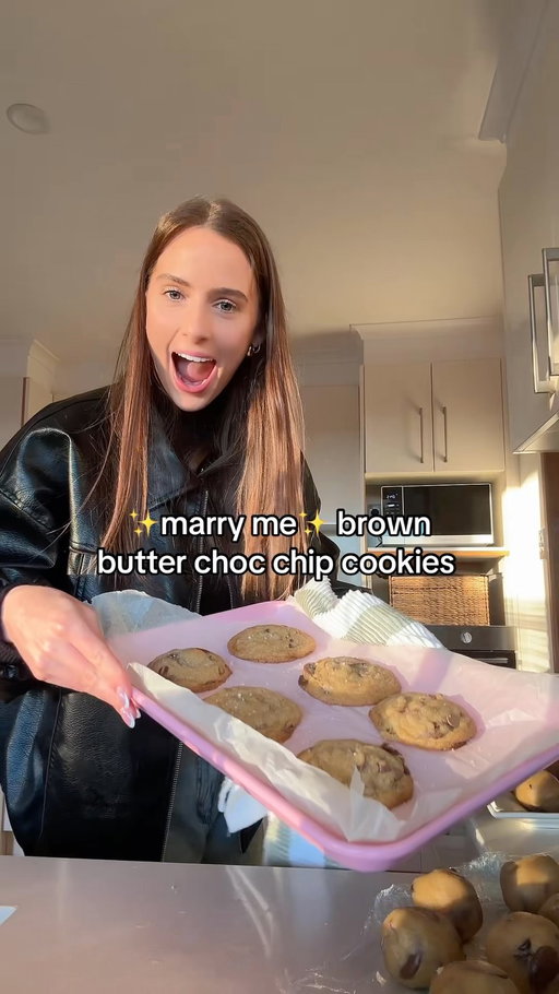 MARRY ME BROWN BUTTER COOKIES 🤤 

Ingredients: 
- 280g of butter (chopped) 
- 320g plain flour 
- 1 tsp baking powder 
- 1/2 tsp baking soda 
- 3/4 tsp salt 
- 165g brown sugar 
- 100g white sugar 
- 1 egg 
- 1 egg yolk 
- 2 tsp vanilla extract 
- 275g milk chocolate chips (I used a mix of large melts and small chips) 
- 100g dark chocolate chips 

Method: 
1. Preheat oven to 180 degrees Celsius/ 350 Fahrenheit and line your baking trays 

2. Add your butter to a wide saucepan (not the pot I did… takes FOREVER) and cook for 3 minutes until the better is melted and starting to bubble. Then cook for another 4-5 extra minutes until the butter turns a little amber colour and the butter starts to separate. 

3. Pour the butter into another bowl to cool down and whisk in both sugars. Leave it on the counter for approx 30 minutes.

4. In another bowl mix together your flour, baking powder, baking side and salt. 

5. Once your butter mixture is cooled whisk in egg, egg yolk and vanilla. 

6. Add the dry to the wet and then stir in the chocolate… the hardest part now is letting it sit in the fridge for another 30 mins. 

7. THEN scoop your balls into balls ( I do 66g balls just a freak and like them even so I can use all the batter lol) for whatever size cookies you’d prefer. 

8. Bake in your oven for 11-13 minutes every oven is different and be mindful of what colour tray you use. A dark tray will heat up faster!!! 

9. Leave to cool and get ready for your boyfriend ro propose!!!