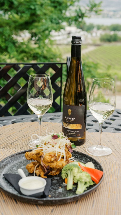 Most people don't think Riesling when they think duck. That's exactly why this pairing works.

Chef Shawn brines these duck wings overnight, orange, rosemary, a full twenty-four hours. Nothing is rushed. The patience in the prep is what you taste at the end, and it's a patience Justin Hall understands from the cellar. Hot honey finish, citrus aioli, rich and layered. It needed a wine that could handle the heat without losing itself.

Our Qwam Qwmt Riesling does exactly that. The name means achieving excellence in nsyilxcən,  not as a destination, but as a practice. The South Okanagan desert produces Riesling differently than anywhere else in Canada. The heat, the sandy soils, the cold nights. The same land that has been stewarded by the Syilx Okanagan people for thousands of years is the land that makes this wine what it is.

The acidity cuts the fat. The stone fruit meets the honey. And suddenly, the heat makes sense.

The duck wings are on the menu at Sweetgrass,  reserve your table at the link in bio. Or bring the Qwam Qwmt Riesling home as part of our Paired wine bundle, available through the link in our bio.

#PairedSeries #NkMipCellars #BCWine #IndiengousOwned #OsoyoosDining