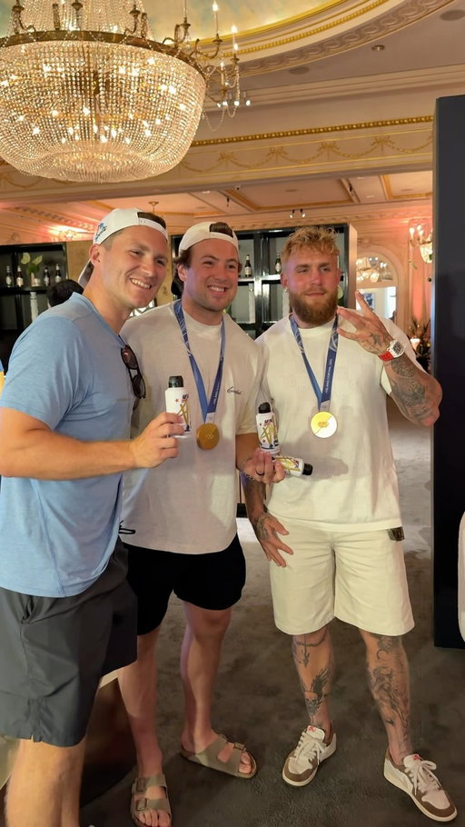 Jake Paul gifts the Olympic USA hockey team custom W cans and try’s on their Gold metal😳