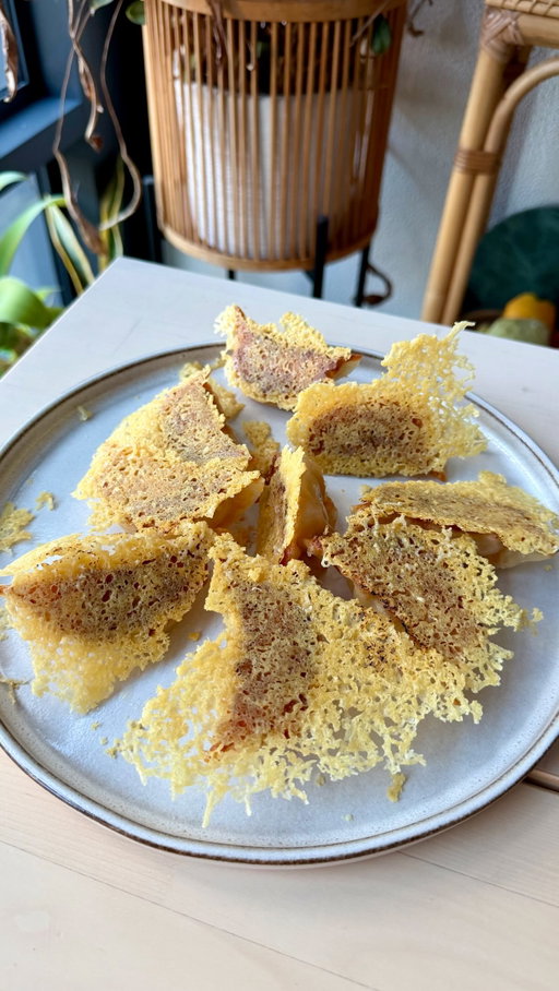 Kimchi Pork Dumplings with Parmesan Lace 🥟🧀

DUMPLINGS
250g pork mince
1/2 tbsp ginger, minced
1 garlic clove, minced
1 tbsp cornstarch
2 tbsp light soy
1 tbsp sesame oil
1 tbsp sugar 
100g kimchi, chopped
mozzarella, cubed
1 x packet dumpling wrappers 

DUMPLING SKIRT 
parmesan, grated

1. Mix pork mince, ginger, garlic, cornstarch, soy sauce, sesame oil, sugar and chopped kimchi in a bowl until well combined.
2. Place a spoonful of filling and a cube of mozzarella into each dumpling wrapper. Fold and seal.
3. Heat oil in a non-stick pan. Panfry & steam dumplings on one side until golden and crisp.
4. In a new pan, lightly oil and sprinkle grated parmesan in a thin, even layer. 
5. Let cheese melt over low heat & place the pan-fried dumplings on top, crispy-side down to let them fuse together for a few seconds.
6. Carefully run a spatula underneath cheese crust once it’s crisped up. Flip out onto a plate & serve immediately.

#dumplings #panfrieddumplings #asianfusion #cheesecrust #parmesancheese