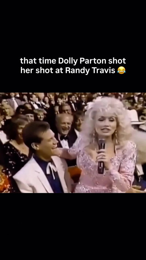 Dolly was wild for that 😂

At the CMA Awards in the late 1980s, Dolly Parton surprised Randy Travis as he stepped up to present, sitting on his lap and telling the crowd that if she were 20 years younger and single she would give him a run for his money. Travis, still early in his career, reddened and laughed along.

The moment marked the start of a lasting friendship. In 1990 the two recorded “Do I Ever Cross Your Mind” together for Travis’s album Heroes & Friends, released that August. After Travis suffered a stroke in 2013 that affected his speech, Parton remained among his public supporters. Both are members of the Country Music Hall of Fame.

#dollyparton #countrymusic #randytravis