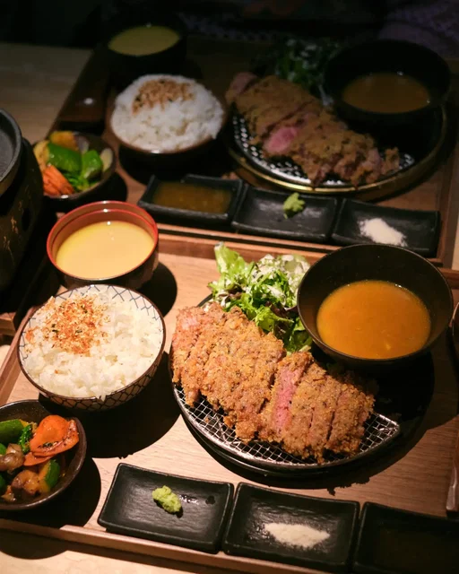 Houston's new gyukatsu restaurant 🥩 Steak gyukatsu is Japanese breaded and deep fried cutlet. At Ryori Lab, there's 3 choices of beef. I opted for the cheapest option of 8 oz of NY strip. The meal comes out and then you're given a hot stone to finish off the beef. The meal also includes a soup, salad, curry sauce, veggies, rice, and 3 seasonings. For $22.90, I think it's a solid meal set!

Other options for beef include beef tongue and A5 wagyu. Gyukatsu is their unique point, but the menu actually has quite a number of other options as well.

🍽️ 2x NY strip gyukatsu plates, honeycomb matcha ice cream

📍 Ryori Lab @ryorilab.tx 
11700 Westheimer Rd # E, Houston, TX 77077

#houstonfood #houstonfoodblogger #westchasehouston #japanesefood