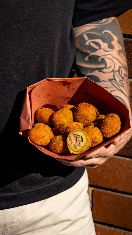 Olive Ascolane 

large green Olives stuff with a delicious savoury beef and pork filling lightly crumb and deep fried in olive oil absolutely delicious. 

Let me know in the comments if you want this recipe.