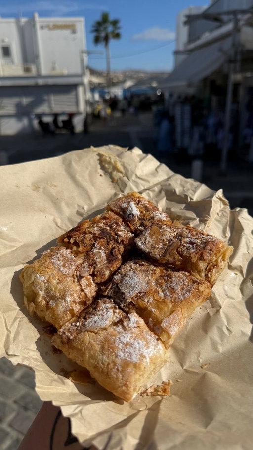 Looking for the best bougatsa in Paros? This local favorite has been perfecting the art of flaky, buttery pastry since 1982 and every bite proves why it’s stood the test of time! 🇬🇷🥐🍮

Bougatsa is a beloved Greek pastry made with layers of crispy, buttery phyllo dough and enjoyed in both sweet and savory varieties. This classic sweet version is filled with silky semolina custard, served warm, then finished with a generous dusting of powdered sugar and cinnamon. 🥐🍮

Would you choose sweet or savory? 👇 My favorite is sweet! ❤️

📍 Bougatsa (Traditional greek pies 1982) Paros, Greece 🇬🇷