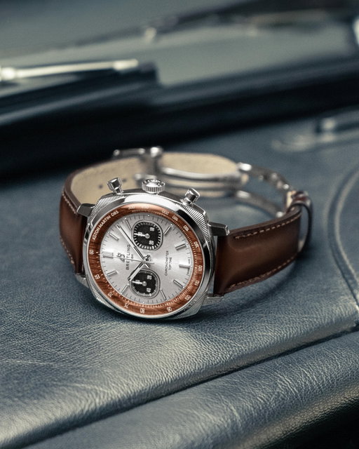 In the steel Top Time Tribute to Aston Martin DB5, the silver-toned dial takes its cue from Silver Birch, the paint color forever linked to the DB5, while the wooden inner bezel recalls the steering wheel and the hand-colored gradient leather strap nods to its rich leather upholstery.