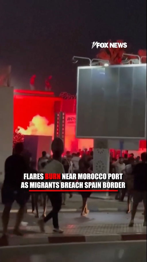People appear to jump from a border wall near Morocco's port of Beni Ansar as flares light up the area.

The scenes unfold amid reported clashes at the nearby crossing into Spain's Melilla, the only open border crossing between Morocco and the Spanish enclave for the past six years.

Spanish authorities estimate roughly 60,000 migrants have entered the nearby enclave of Ceuta over the past 24 hours after crossing by land and sea from Morocco.