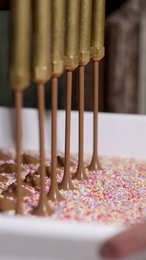 If you’ve ever wondered where a Speckle get its speckles, here is the answer.
 
Each one begins with smooth milk or dark chocolate, gently dropped into a colourful bed of natural sprinkles to create our most cheerful chocolate.
 
Step behind the scenes with us to see a little chocolate magic.