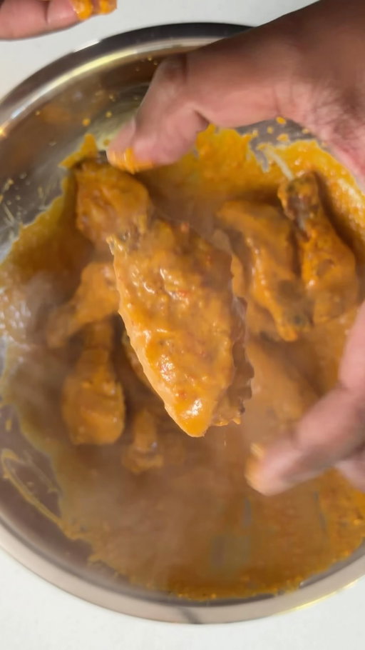 Buffalo Butter Chicken Wings

Ingredients

Wings
1kg chicken wings
½ tsp smoked paprika
1 tsp garam masala
1 tsp garlic powder
1 tsp Kashmiri chilli powder
2 tbsp baking powder

Sauce
1 small shallot or onion, diced
4 chillies, chopped
3 garlic cloves, minced
1 thumb-sized piece ginger, grated
2 tbsp tomato paste
1 tsp cumin
1 tsp garam masala
1 tsp Kashmiri chilli powder
½ tsp turmeric
½ tsp smoked paprika
1 cup chicken stock
1 tbsp apple cider vinegar
1 tsp kasoori methi
2 slices Kraft Singles
20g butter
Salt, to taste

Method
Pat the wings dry and toss with the spices and baking powder. Arrange on a greased tray or wire rack and bake at 150°C for 25 minutes, turning halfway. Increase the oven to 220–230°C and cook for a further 15 minutes, turning halfway, until golden and crispy.
Meanwhile, cook the shallot in 2 tbsp oil until lightly golden. Add the ginger, garlic and chillies and cook for 2–3 minutes. Stir in the tomato paste and cook for 2 minutes, then add the cumin, garam masala, Kashmiri chilli, turmeric and smoked paprika and toast for 30 seconds. Pour in the chicken stock and simmer for a few minutes before adding the apple cider vinegar, kasoori methi, cheese and butter. Blend until smooth, return to the saucepan, and season with salt and extra vinegar if needed.
Toss the hot wings through the sauce until evenly coated and serve immediately.