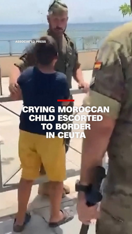 Video shows Spanish soldiers escorting a sobbing Moroccan boy toward Ceuta’s border with Morocco. It comes days after around 60,000 migrants charged into the Spanish exclave.