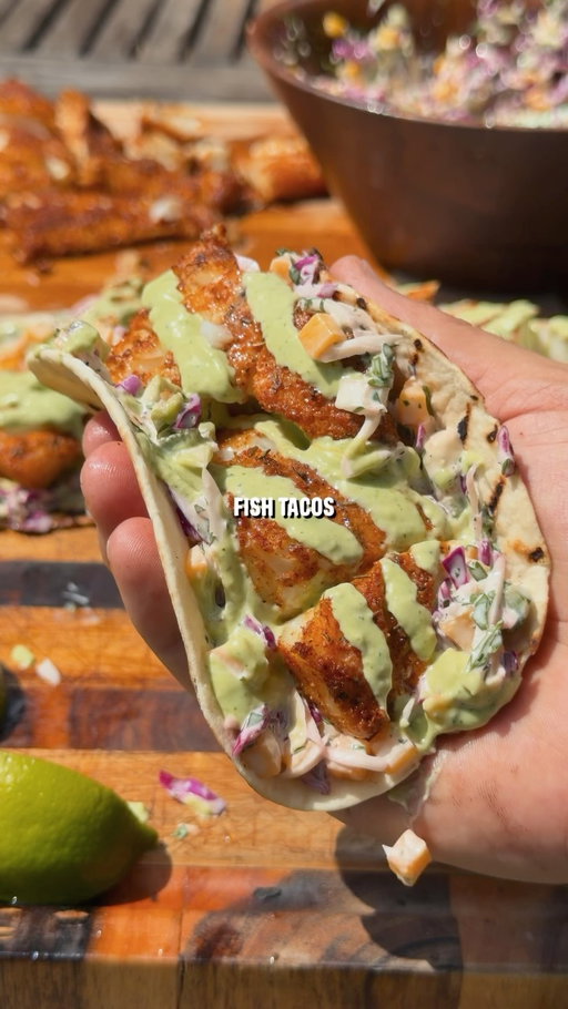 Fresh Mango Slaw Blackened Fish Tacos 🌮 The perfect dish for a hot summer day. 

Recipe:
-Cut the cod into pieces, drizzle with oil, and season with blackened seasoning.
-Grill indirect with the vents wide open until reaching 145F internal.
-Make the mango jalapeño slaw by mixing together 1 cup red cabbage, 1 cup green cabbage, 1 diced jalapeño, 1/4 cup cilantro chopped, 1 diced mango, 1/2 cup mayonnaise, 1 whole lime juiced, salt and pepper to taste.
-Make green sauce by blending 1 cup greek yogurt, 1 avocado, 1 fresh jalapeño, 4 garlic cloves minced, 1/4 cup chopped cilantro, juice of 1 lime, 1/4 cup water, salt and pepper to taste.
-Grill the tortillas, then assemble tacos with slaw, grilled fish, lime juice, and the green sauce.

#fishtacos #grilledfish #tacotuesday #tacos #grilling