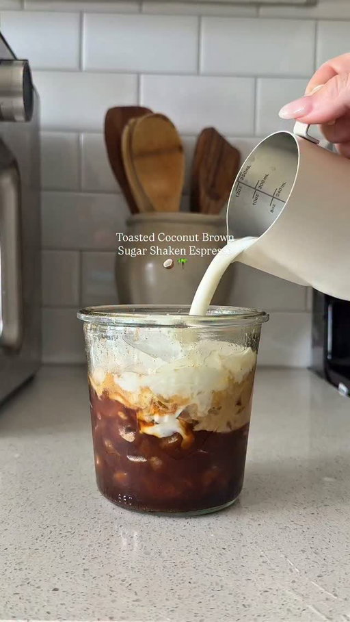 The perfect latte for a hot Summer day here in TX 🥵 
Coconut Brown Sugar Shaken Espresso ☕️🥥🌴 using the toasted coconut syrup by @amoretti 

Recipe: 
Brew 2 shots espresso over- 
1 tbsp brown sugar 
1 bsp toasted coconut syrup 
1 tsp vanilla bean paste 
Pinch of salt 
Dash of cinnamon 

Shake over ice- add milk & enjoy 🫶🏼 

#coffeeathome #CoffeeRecipe #shakenespresso #coffeetiktok