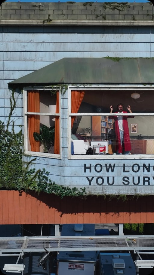 A Man Is Living in a Billboard for the Next 48 Hours at Sunset Blvd and Selma Avenue in Hollywood to promote the new Netflix movie “The Last House” the man is interacting with people on the street and crowds are showing up to check out the spectacle!