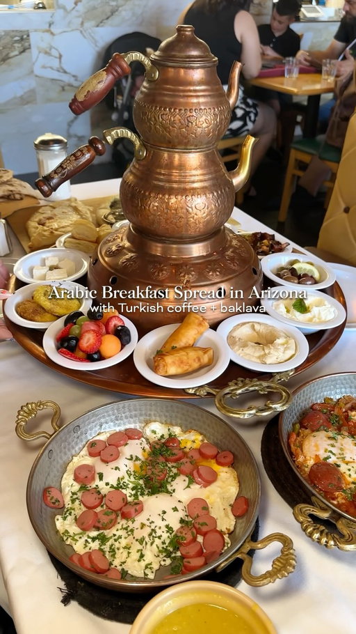 🍳🧆 Definitely a unique spot in Gilbert is Rayoog Cafe. This was my first time having Arabic and Turkish breakfast with this beautiful breakfast spread (called Special Mam’s that includes hummus, salad, baba ghnogh, yogurt, shakshuka eggs, and more). Definitely order the Turkish coffee and baklava with ice cream, Nutella and pistachio to finish off your meal. This can feed 2-3 people for sure and we had plenty of leftovers after. Highly recommend if you’ve never been! 

@rayoogcafe 
📍 78 N Cooper Rd Ste 101, Gilbert, AZ 85233