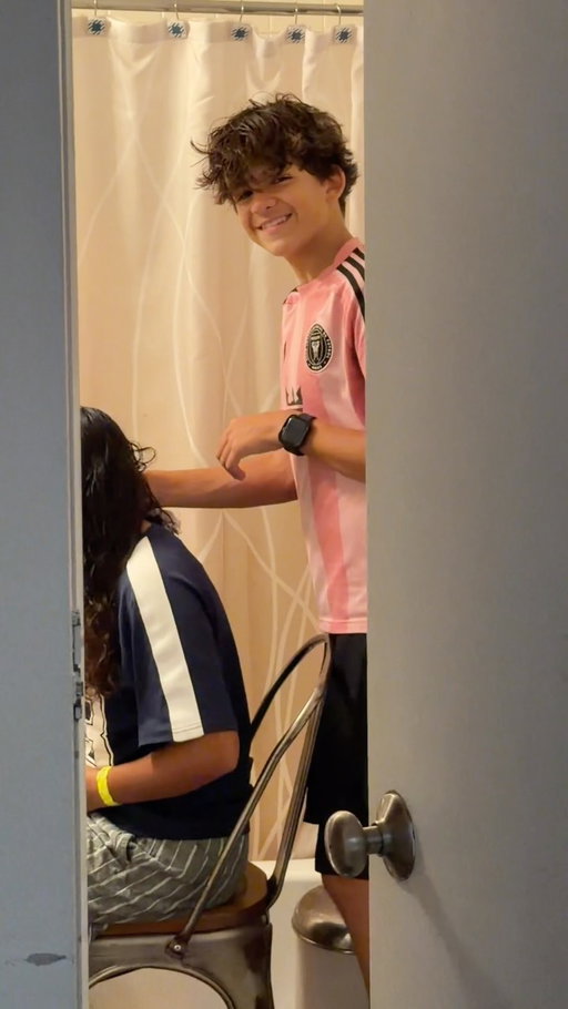 When a brother misses his sister.  After the girls were away at sleep away camp, they came yesterday and this morning now Avery and Lilah are going to soccer day camp and this is what I see 🥹 Him helping her with her hair.