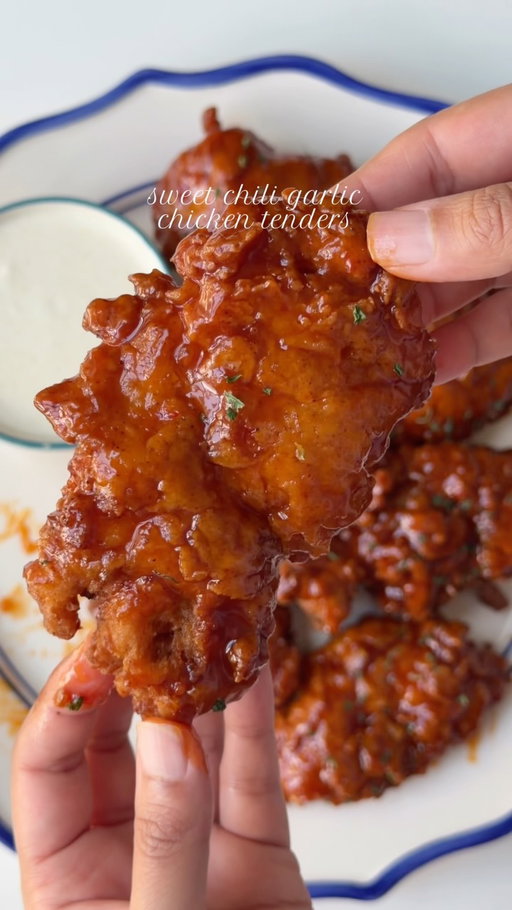 Sweet chili garlic chicken tenders. 

Ingredients 

1 lb chicken tenders

For the wet batter:

1 1/2 cup butter milk
2 tbsp lemon juice 
2 tbsp soy sauce 
1/4 cup hot sauce 
Salt to taste
1 tbsp garlic powder 
1 tbsp onion powder 
1 tbsp smoked paprika powder 
1 tsp black pepper powder 

For the dry batter:
2 cups all purpose flour
1/2 cup corn starch 
2 tbsp baking powder 
Salt to taste
1 tbsp garlic powder 
1 tbsp onion powder 
1 tbsp smoked paprika powder 
1 tsp black pepper powder 

For the sweet chili garlic sauce 

1/3 cup honey 
2 tbsp ketchup 
1 tbsp soy sauce sauce 
1 tbsp fresh lemon juice 
1/4 cup hot sauce 
1 tbsp chili garlic sauce 
3 cloves garlic, minced
Salt to taste
2 tbsp butter, cold

For the ranch dressing 
1/2 cup mayonnaise
1/4 cup sour cream
2 tbsp buttermilk
1/2 tsp garlic powder
1/2 tsp onion powder
1/2 tsp dried parsley
1/4 tsp dried dill
1/4 tsp black pepper
1 tsp lemon juice
Salt to taste

Method:
Marinate chicken with buttermilk, lemon juice, soy sauce, hot sauce, garlic powder, onion powder, smoked paprika, black pepper, and salt. Mix well, cover, and refrigerate for at least 30 minutes, or 2–4 hours for the best flavor and tenderness.
In a bowl, whisk together flour, cornstarch, baking powder, garlic powder, onion powder, smoked paprika, black pepper, and salt.
Remove chicken from the buttermilk mixture and coat well in seasoned flour, pressing the flour onto the chicken. Dip back into the reserved buttermilk marinade, then coat again in flour, pressing and squeezing the flour onto the chicken for a thick, craggy coating. Let rest for 5–10 minutes.
Heat oil to 350°F and fry in batches for 4–6 minutes, turning occasionally, until golden and the chicken reaches 165°F. Transfer to a wire rack to keep crispy.
For the sauce, add honey, ketchup, soy sauce, lemon juice, hot sauce, chili garlic sauce, garlic, and salt to a saucepan. Simmer over medium-low heat for 2–3 minutes until glossy and slightly thickened. Turn heat to low and whisk in the cold butter.
Lightly brush the sweet chili garlic glaze over the chicken tenders.
For the ranch, whisk everything together and refrigerate for 15–30 minutes.
Serve with ranch and enjoy