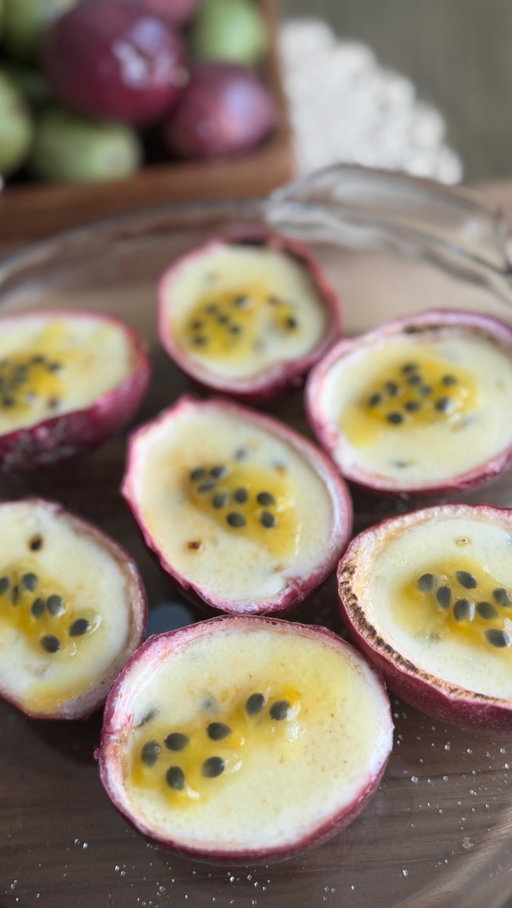 Passion Fruit Posset with Caramelized Sugar

Serves 4–6

Posset

2 cups (475 mL) heavy cream
½ cup (100 g) granulated sugar
Pinch of salt
4-6 ripe passion fruits
1 tsp fresh lemon juice, only if your passion fruit isn’t particularly tart

For the brûléed topping

1–2 teaspoons superfine/caster sugar per serving

Method

Prepare the passion fruit
Cut the fruits in half and scoop the pulp and seeds into a bowl.
Measure out about ½ cup.
Keep the seeds, don’t strain.

Make the posset
Put the cream, sugar and salt in a saucepan.
Bring to a gentle boil over medium heat, stirring until the sugar dissolves.
Once it reaches a proper boil, simmer for 3 minutes, stirring occasionally.
Remove from the heat.

Add the passion fruit
Let the cream cool for about 5 minutes.
Stir in the passion fruit pulp and seeds.
Add the lemon juice if needed.
Divide between shallow ramekins or small serving glasses.

Chill
Refrigerate for at least 4 hours, preferably overnight.
The surface needs to be completely cold and firmly set before brûléeing.

Caramelize the top
Just before serving, blot any moisture from the surface with a very gentle touch of paper towel if necessary.
Sprinkle a thin, even layer of sugar over each posset.
Use a kitchen torch to caramelize the sugar, moving the flame continuously until it melts and turns deep golden brown.
Let it sit for 1–2 minutes so the caramel hardens.
