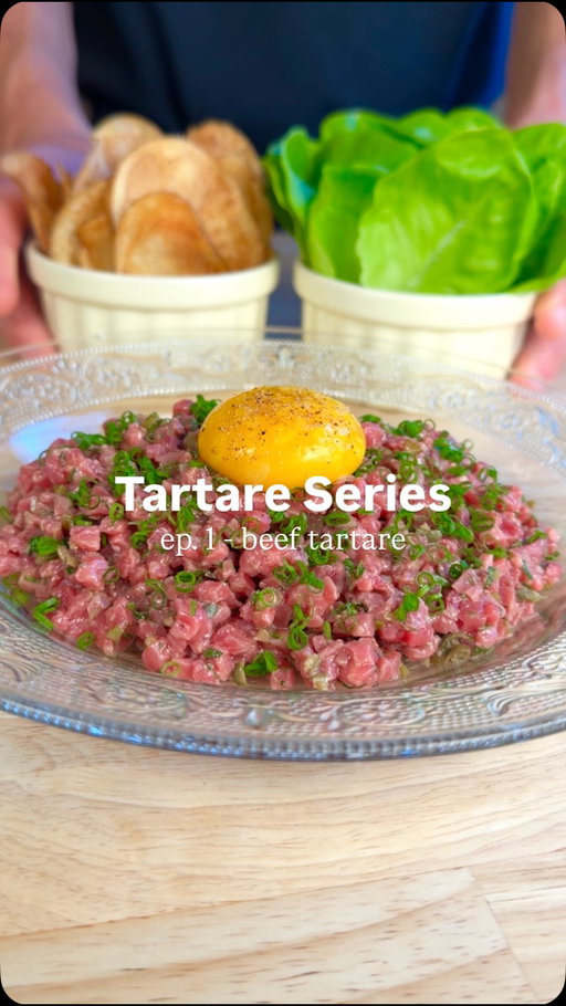 How to Make Steak Tartare 🥩 - THE TARTARE SERIES ep. 1 

FULL RECIPE BELOW ⬇️ 

INGREDIENTS:
- 250g beef (SEE NOTES IN THE COMMENTS ON CHOOSING THE RIGHT CUT)
- 1/2 small shallot
- 1 tbsp chopped gherkin pickles
- 1 tbsp chopped capers
- 1 tbsp chopped parsley
- 1/4 bunch chives 
- 1 tsp Dijon mustard
- 1 tbsp lemon
- 2 tbsp olive oil
- tobasco, Worcestershire to taste
- salt and fresh cracked pepper to taste
- 1 large russet potato 
- 1L canola oil (for frying)
- 1 head gem lettuce
- 1 egg yolk

INSTRUCTIONS:

TARTARE: 🥩
1) Thinly slice your beef approx. 3 mm thick, and lay the strips on a sheet pan lined with parchment paper. Place the tray in the freezer until the beef is semi-frozen.
2) While waiting for your beef to freeze, finely chop your shallot, gherkins, capers, and parsley. Finely chop your chives and set aside.
3) When your beef is semi-frozen, dice it into approx. 3mm dice. While you are dicing, keep your beef on the frozen tray, as it will keep it cold. 
4) In a large chilled bowl, mix your Dijon, lemon juice, and olive oil, along with a few dashes of tobasco and Worcestershire. Keep whisking until the dressing has emulsified. Add your beef to the bowl, along with your shallots, parsley, gherkins and capers. Season with salt and freshly cracked pepper. Taste your tartare and adjust the seasoning. 
5) Plate your tartare on a chilled plate, garnish with chives and your egg yolk. Serve with potato chips and lettuce leaves.

RECIPE CONTINUES IN THE COMMENTS ⬇️

#steak #tartare #beef #recipe #homecooking