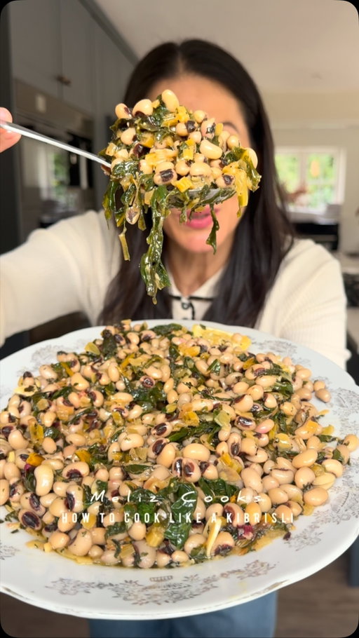 How to cook like a Kıbrıslı: Melek Nene’s Pazılı Kuru Börülce (Pan Fried Chard & Black Eyed Beans) Meliz’s Kitchen 🫘 🧅 🧄🌿🍋🫒 
Serves 6–8
450g cooked black eyed beans* (see notes pinned comment) 
200 g (7 oz) Swiss chard roughly chopped (stems removed, finely chopped and kept to one side) or the same quantity of spinach
3 tbsp olive oil
1 large onion, peeled and finely diced
1/2 tsp sea salt flakes 
4 garlic cloves, finely sliced

For the dressing
4 tbsp extra virgin olive oil, plus extra to serve
4 tbsp lemon juice
1 tsp sea salt flakes
1 tsp dried mint

METHOD: 

If using dried black eyed beans, spread them out evenly on a large tray and remove and discard any stones or broken beans. Soak and cook as per the instructions below. You can check that they’re cooked by squeezing one of the cooked beans in between your thumb and
forefinger. Once cooked, remove pan from heat, drain the beans in a colander. You cook prepare these the night before too but I love using them when they’re still warm from being freshly cooked as the beans soak up the flavour and juices of the remaining ingredients better this way. 

Wash the chard thoroughly to remove any dirt or grit before roughly chopping the leaves.
In a frying pan, heat olive oil, add onion, along with 1/2 tsp sea sally flakes, soften over a low heat for 12–15 minutes until translucent. Add the finely chopped chard stalks and cook for a few minutes more. Once softened, increase the heat a little so the onions and chard stalks start to caramelise, then add the garlic, turn the heat down again and cook for another 2 minutes. Add the chopped chard leaves to the pan, reduce the heat and cook until the greens have wilted. Remove the pan from the heat, add the drain beans to the pan and stir well until the beans are fully coated in the greens, onions and garlic.

Transfer the mixture to a serving dish.
Drizzle and sprinkle over all of the dressing ingredients, stir well and serve with an extra drizzle of extra virgin olive oil. It’s the perfect accompaniment to Badadez Köftesi (coming soon) and fresh or canned fish such as tuna or smoked mackerel, chips, bread and a fresh salad.

#meliz