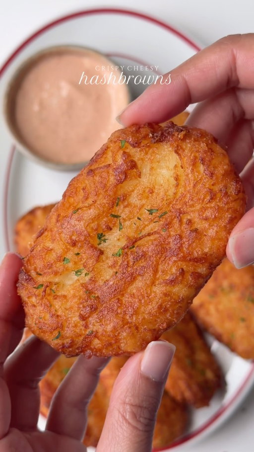 Crispy cheesy hashbrowns

Ingredients 

8-9 medium russet potatoes 
5 tbsp corn starch
4 oz shredded cheddar cheese 
Salt to taste
1 tsp black pepper 
1 1/2 tsp garlic powder 
Oil for frying 

For the sauce 

1/2 cup mayonnaise 
2 tbsp ketchup 
1 tbsp hot sauce 
Salt to taste
1 tsp garlic powder 
1/2 tsp black pepper 
1/4 tsp smoked paprika powder 
1 tsp lemon juice 

Method 
Peel the potatoes Add to a pot of salted water and boil for about 8 minutes, just until they are partially cooked. They should still be firm in the center. Drain the potatoes very well and let them cool until they’re easy to handle. Grate them using the large holes of a box grater. Spread the grated potatoes out for a few minutes to allow excess steam to escape. If they feel particularly wet, gently squeeze out any excess moisture.
Add the grated potatoes, cornstarch, cheddar cheese, garlic powder, black pepper, salt. Gently mix until everything is evenly combined.

Take a portion of the mixture and firmly press it into a thick rectangle or oval. Repeat with the remaining mixture.
Heat about 1 inch of oil in a skillet over medium heat to 360°F. 
Carefully add the hash browns and fry for about 3–4 minutes per side, or until deeply golden and crispy.
Transfer to a wire rack or paper towel-lined plate and let the excess oil drain.
For the sauce 
Mix mayonnaise, ketchup, hot sauce, garlic powder, black pepper, salt, and lemon juice (or pickle juice) until smooth and creamy.
Serve the hash browns hot and crispy with the dipping sauce. 

#recipe #hashbrowns #cheese