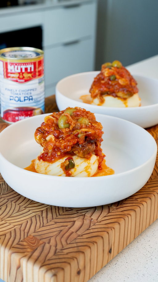 Mediterranean-Style Tomato-Braised Chicken Thighs

This is one of those easy weeknight meals that tastes like you put in way more work than you actually did. Chicken thighs braised in @mutti_canada Polpa with fennel, shallots, garlic, Calabrian chili, olives and capers, then finished with fresh parsley.
I love using Mutti Polpa here because the tomatoes are picked at the right stage of ripeness and processed to preserve their fresh, vibrant tomato flavour. Mutti works closely with around 800 selected tomato-growing families in Italy, building long-term, transparent relationships to help produce consistently high-quality tomatoes.
Serve this with creamy mashed potatoes, rice, or some crusty bread to soak up all that tomato sauce.

RECIPE
Ingredients  • 4 bone-in, skin-on chicken thighs  • 2 tbsp olive oil  • 1 shallot, thinly sliced  • 2 garlic cloves, thinly sliced  • 1 fennel bulb, trimmed and thinly sliced  • 1 tbsp Calabrian chili paste  • 1 can Mutti Polpa  • 1/4 cup olives  • 1 tbsp capers  • 1 tsp paprika  • Salt, to taste  • Freshly cracked black pepper, to taste  • Fresh parsley, chopped
Method
1. Season the chicken thighs generously with salt, pepper and paprika.
2. Heat the olive oil in a large oven-safe skillet over medium-high heat. Place the chicken skin-side down and sear until deeply golden and crisp. Flip and sear the other side. Remove the chicken and set aside.
3. In the same pan, add the shallot, garlic, Calabrian chili and fennel. Season lightly with salt and cook until the vegetables soften and become fragrant.
4. Add the Mutti Polpa and bring everything to a gentle simmer. Season with salt and freshly cracked black pepper.
5. Stir in the olives and capers, then nestle the chicken thighs back into the sauce, skin-side up.
6. Transfer to a 350°F oven and cook for approximately 30–40 minutes, or until the chicken reaches at least 165°F internally. For a more tender braised texture, I like taking the chicken a little beyond the minimum safe temperature.
7. Finish with plenty of fresh parsley and serve with mashed potatoes, rice, or crusty bread.