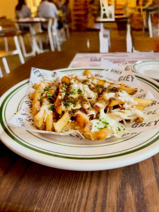 Disco Fries anyone? 🪩🕺
@greysdinerclt

Crispy fries with mozzarella and short rib gravy - the combo I never thought I wanted and now I dream about it 💭

The most tender succulent pork chop ever 🐖

Fried Green Tomato Po’ Boy 🍅
Getting all of my veggies!

Just a cameo of Keith digging into his pork chop while I’m trying to capture this sandwich 🤣

Keith’s plate was clean before I started eating - he ordered a second pork chop to go for the next day 🙋‍♂️
He’s a man who knows what he likes 💯

We never say no to coconut layer cake - NEVER 🥥